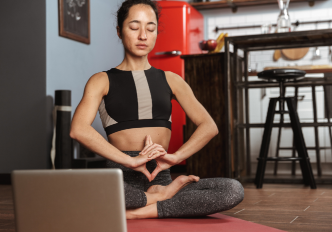 Woman meditating at home. Vancouver studios offering online yoga classes.