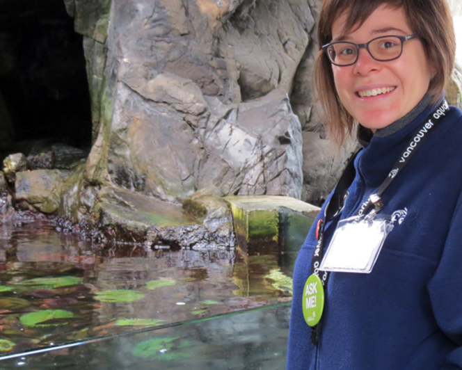 A naturalist stands next to the Touch Pool exhibit at the Vancouver Aquarium