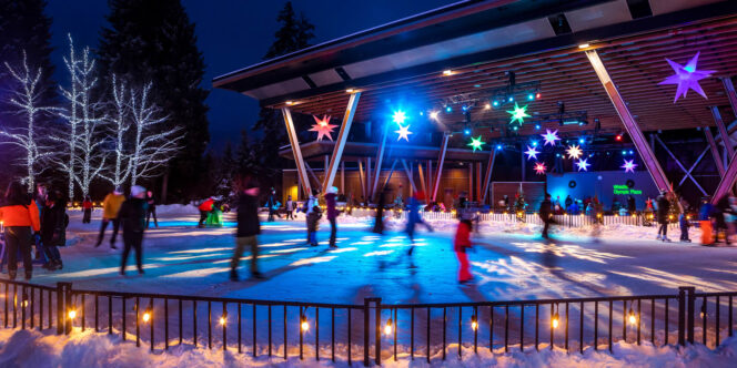 People skating on an outdoor ice rink at night in Whistler, BC