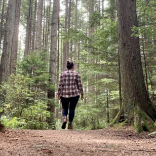 A woman walks along a trail in Pacific Spirit Regional Park in Vancouver