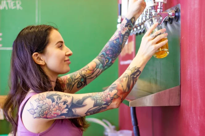 A server pours a beer at Maple Meadows Brewing
