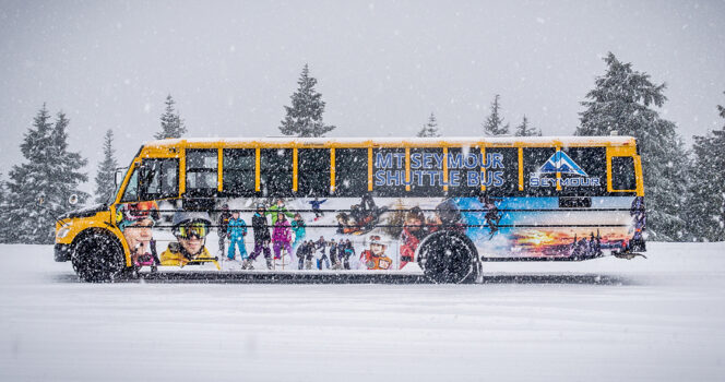 The Mount Seymour shuttle bus sits in a snowy parking lot