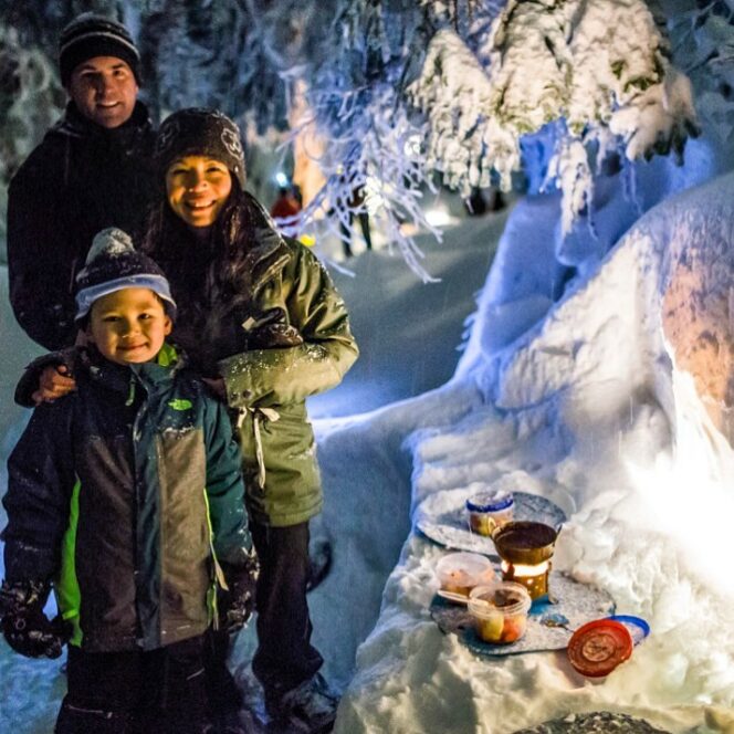 A family enjoys outdoor chocolate fondue on a snowshoe tour at Mount Seymour