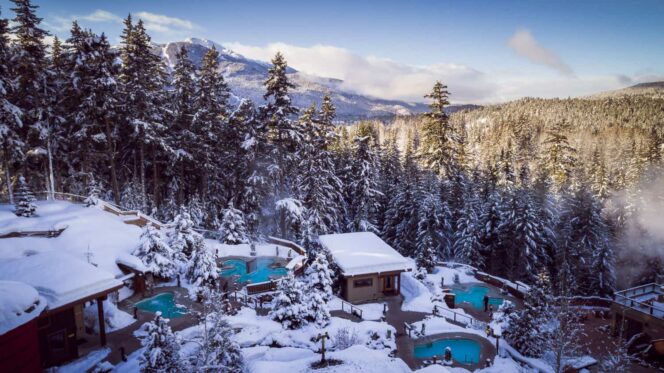 A view of the outdoor pools at Scandinave Spa Whistler in the snow
