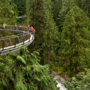 People walk on a suspended walkway at the Cliffwalk at Capilano Suspension Bridge in North Vancouver