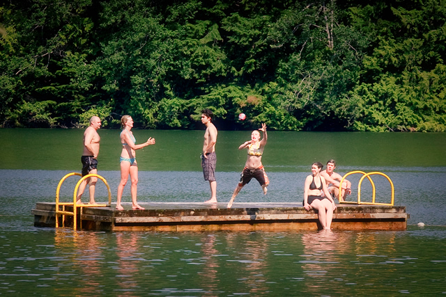 Swimmers jump off a raft at Alice Lake Provincial Park