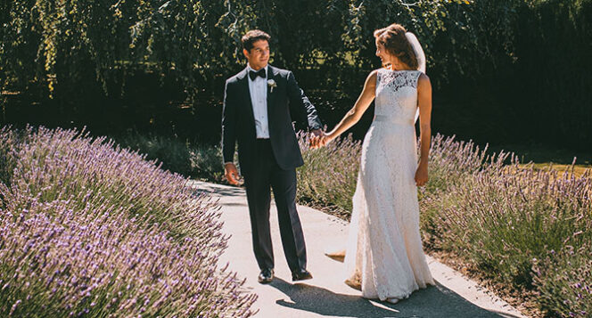 A bride and groom at the Lavender Walk in Van Dusen Garden