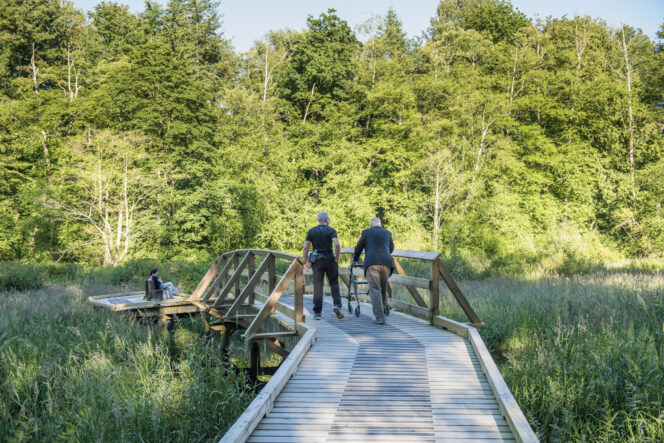 People walk on a boardwalk at Campbell Valley Regional Park in Langley