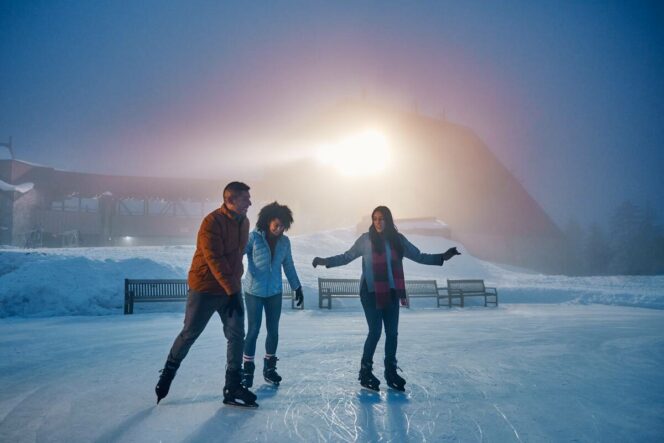 Three people ice skating at Grouse Mountain near Vancouver