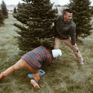 Two men cut their own Christmas tree