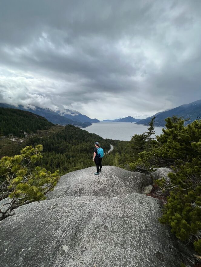 A woman stands at Quercus Viewpoint in Murrin Provincial Park