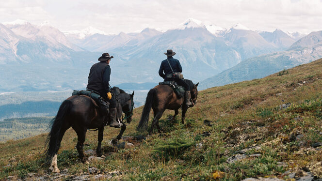 Two men on horseback in British Columbia's Muskwa-Kechika region in a still from the film In the Land of Dreamers