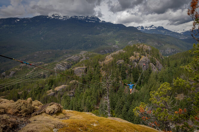 A person walks across a highline between two rocky outcroppings in Squamish. A still from the film The Squamish Highliners' Journey
