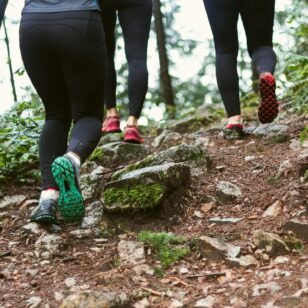 Close up of women's shoes as they run up a trail
