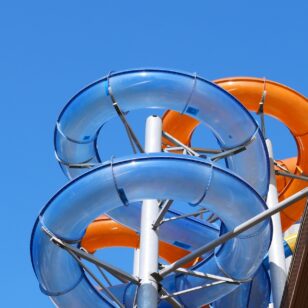 Waterslides silhouetted against blue sky