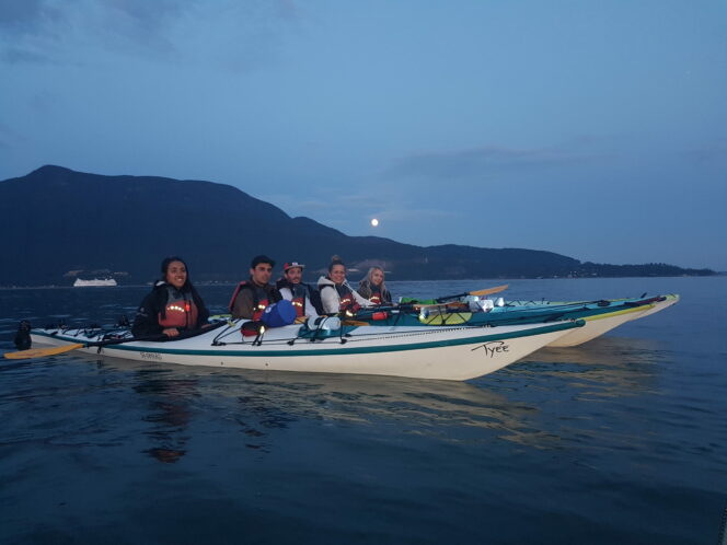 A group of paddlers during the full moon