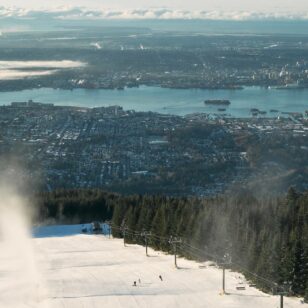 An aerial view of skiing at Grouse Mountain with the city in the background.