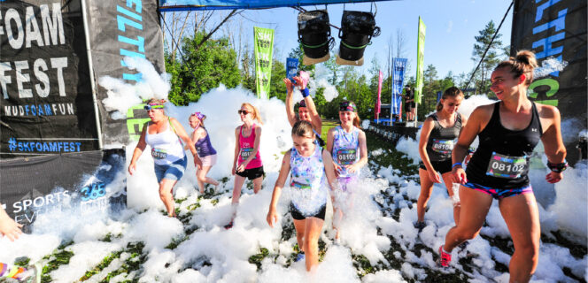 Participants cross the finish line at the 5K Foam Fest in Surrey