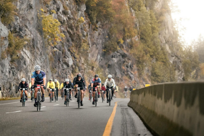 Cyclists biking the Sea-to-Sky Hwy during the RBC GranFondo Whistler.