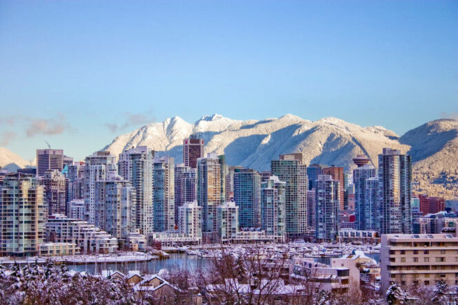 Downtown Vancouver with snow on the North Shore Mountains. 