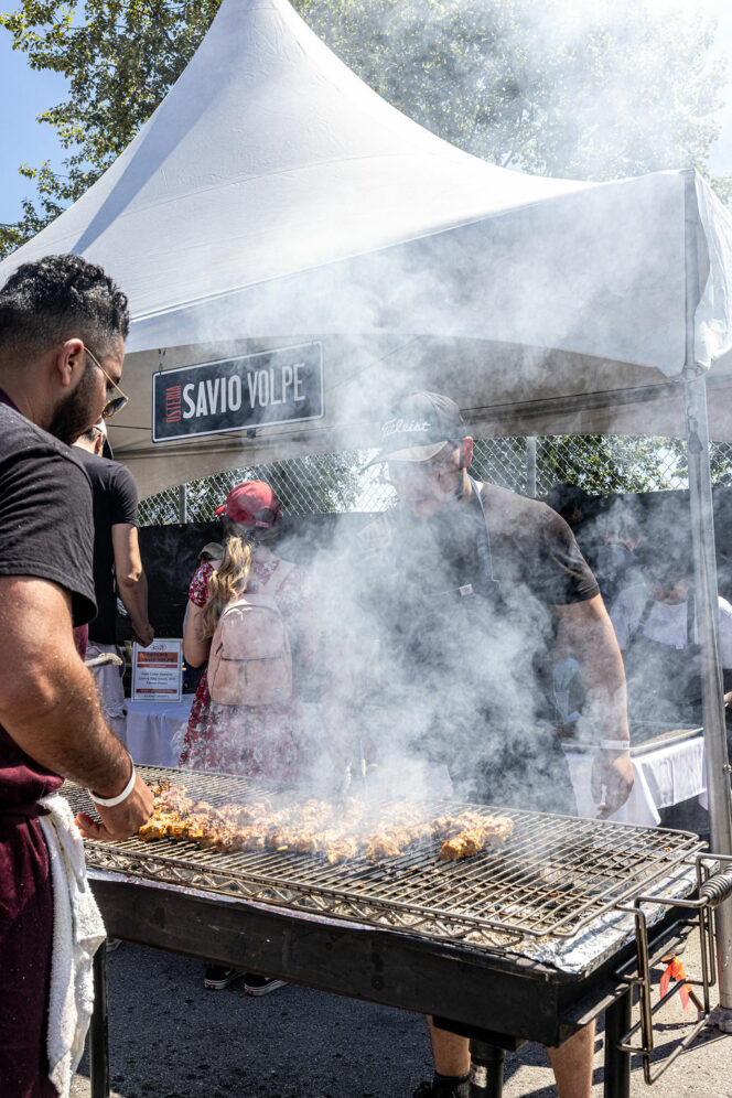 Chefs prepare meat at the Brewery and the Beast festival in Vancouver