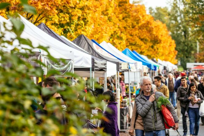 People shopping at booths at the Trout Lake Farmers Market in Vancouver